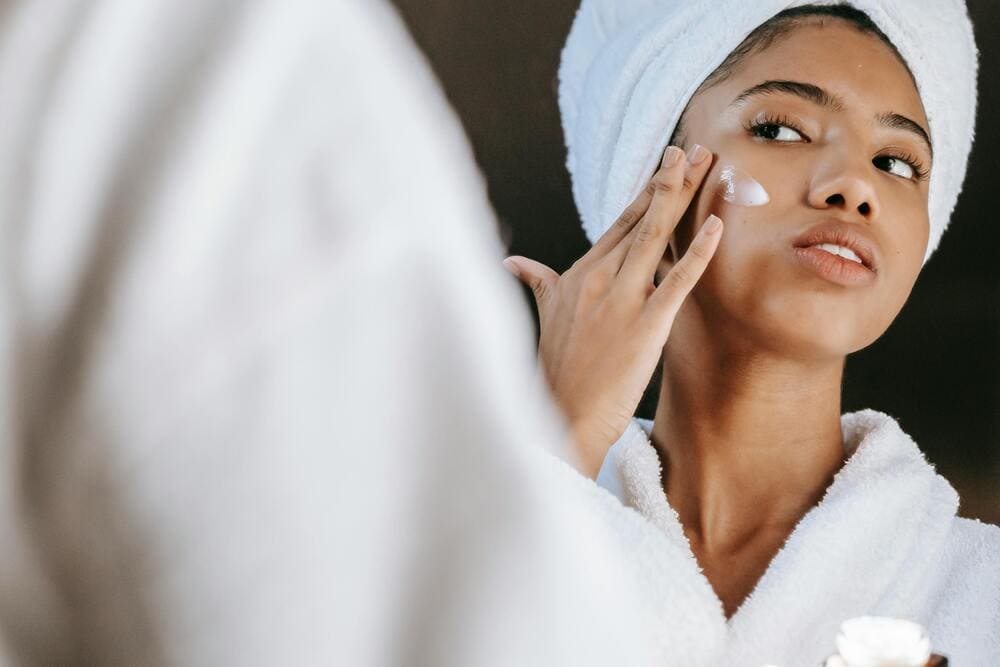 woman using skin hydration product on her face