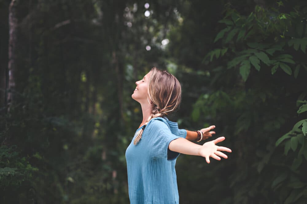 woman-with-open-arms-connecting-with-nature