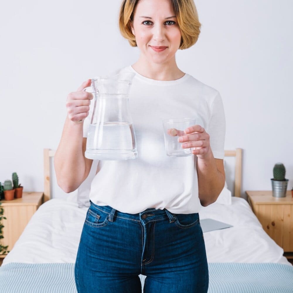 beautiful-woman-with-water-near-the-bed