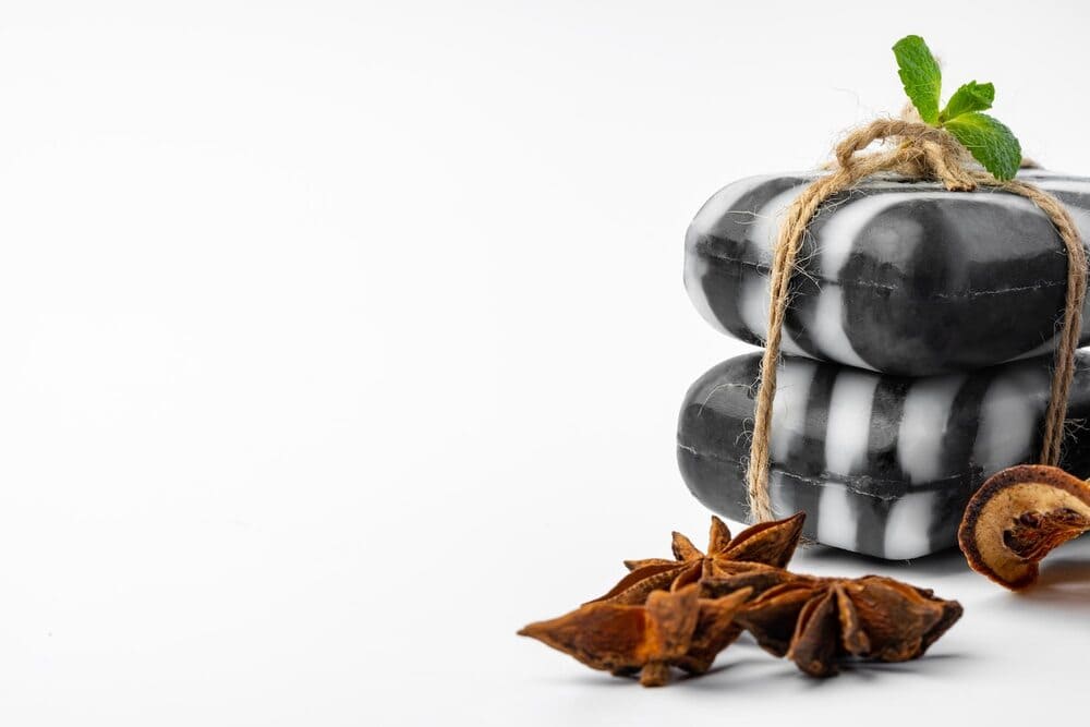 pieces-of-natural-black-handmade-soap-on-white-background