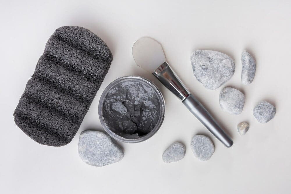 pumice-stone-spa-stones-clay-mask-and-brush-on-white-background