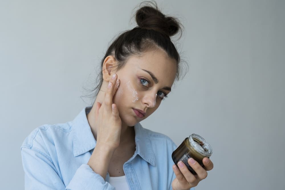side-view-woman-applying-face-treatment