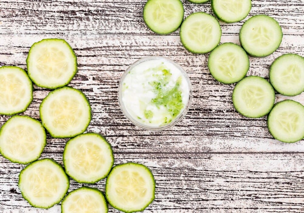 top-view-sliced-cucumber-with-white-yogurt-in-glass-bowl-on-white-wooden-horizontal