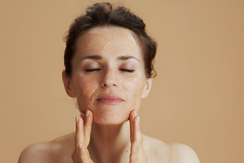 woman-applying-skin-exfoliator