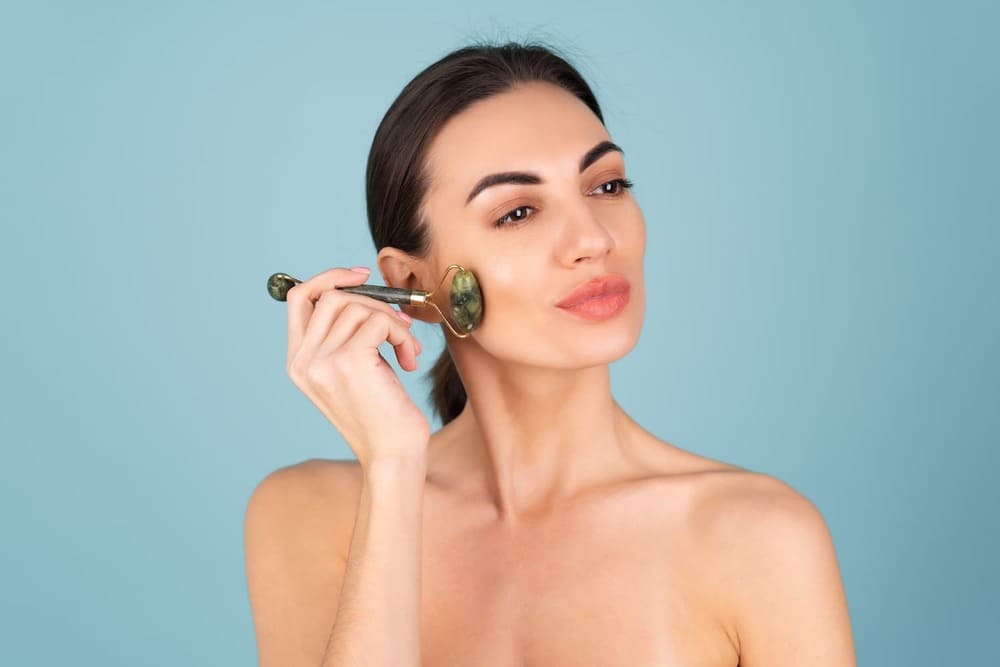 woman-using-face-roller-massage