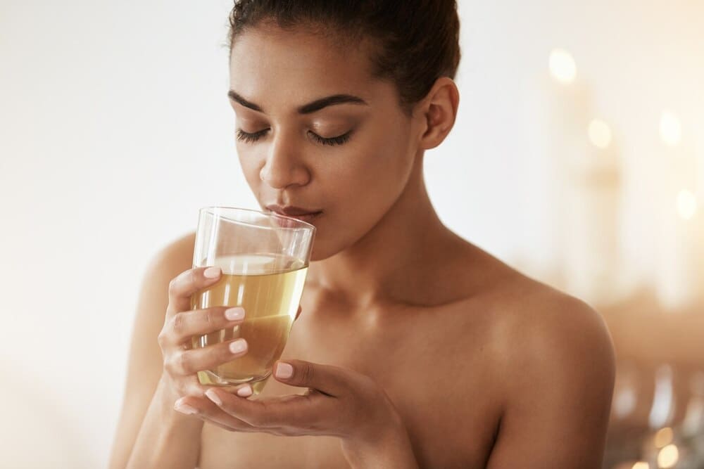 beautiful-woman-drinking-Herbal-Teas-smiling-relaxing-in-spa-salon