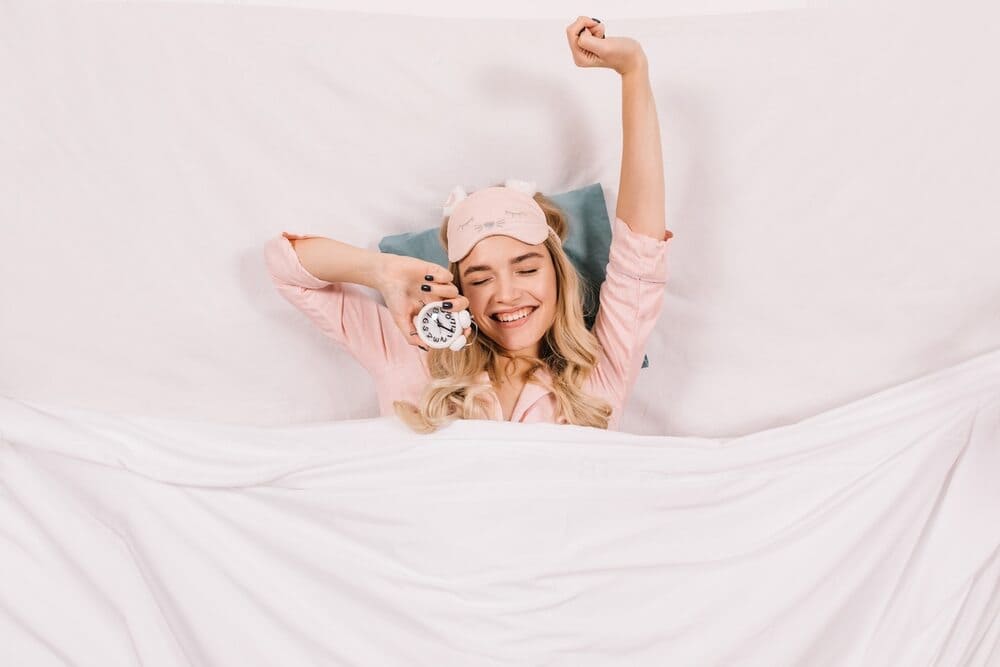 woman-cheer-up-stretching-in-bed